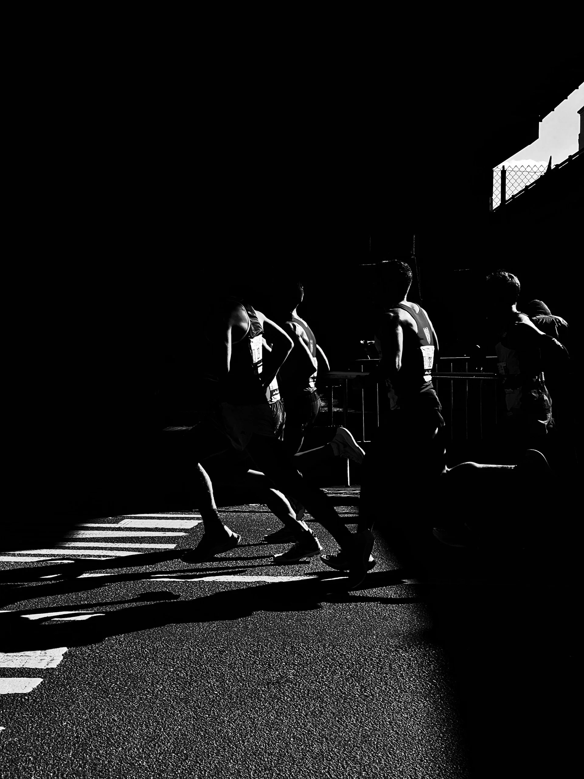 Runners lit from behind at dawn